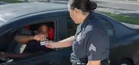 Man Giving His Driver's License to the Policewoman